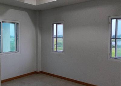 Empty bedroom with three windows