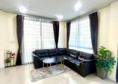 Modern living room with black sectional sofa and coffee table