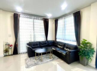 Modern living room with black sectional sofa and coffee table