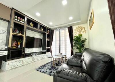 Modern living room with marble entertainment center and leather sofas