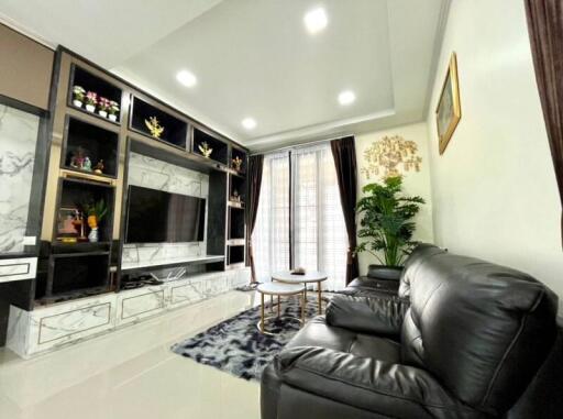 Modern living room with marble entertainment center and leather sofas