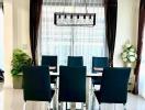 Modern dining room with sleek black chairs and elegant chandelier