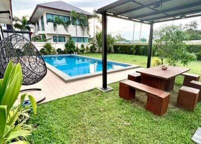 Outdoor garden area with pool and seating area