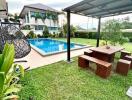 Outdoor garden area with pool and seating area