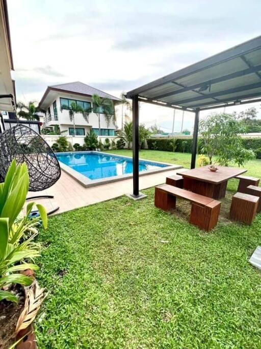 Outdoor garden area with pool and seating area