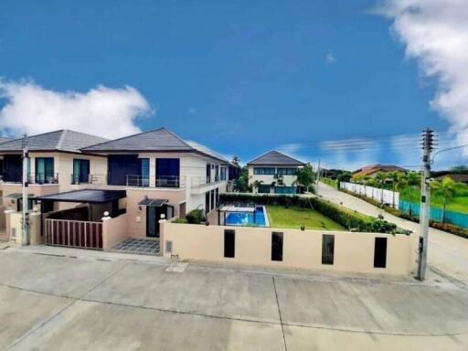 Modern two-story house with spacious front yard and swimming pool