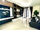 Modern living room with black leather sofas and decorative shelving