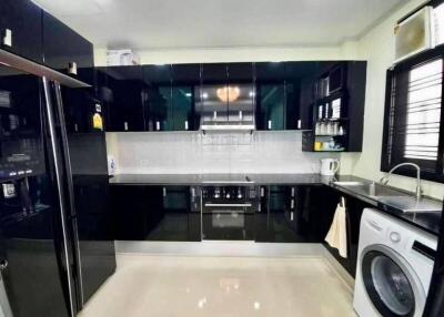 Modern kitchen with black cabinets and appliances