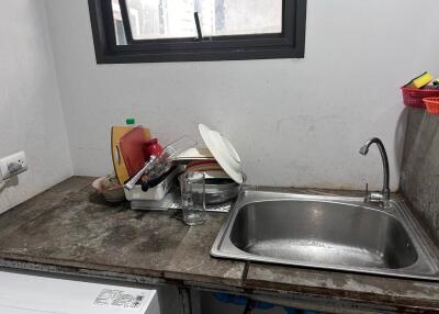 Small kitchen with stacked dishes and sink