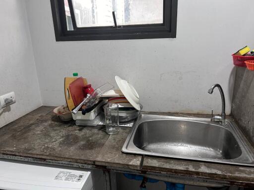 Small kitchen with stacked dishes and sink