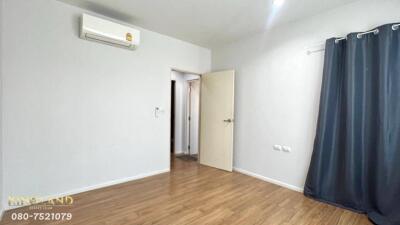 Bedroom with wooden floor, air conditioner, and open door