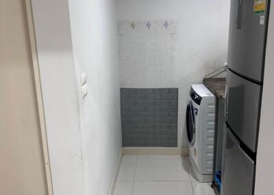 Laundry area with washing machine and refrigerator