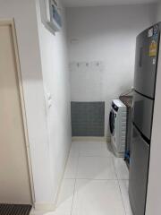 Laundry area with washing machine and refrigerator