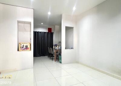 Spacious living area with tiled flooring, dining space partially visible