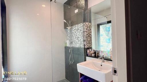 Modern bathroom with glass-enclosed shower