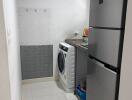 Small kitchen space with washing machine and refrigerator