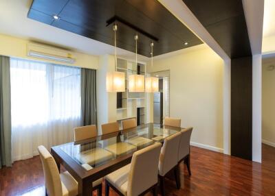 Modern dining room with glass table and cushioned chairs