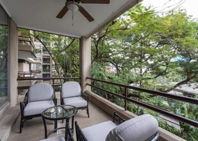 Cozy balcony with seating and ceiling fan