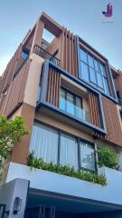 Modern multi-level building facade with large windows and balconies