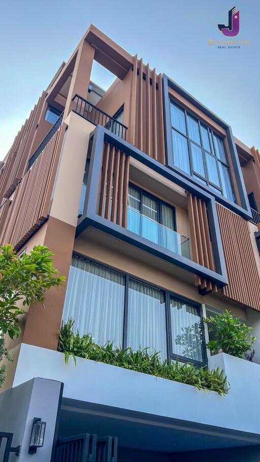 Modern multi-level building facade with large windows and balconies