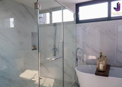 Modern bathroom with glass shower and freestanding tub