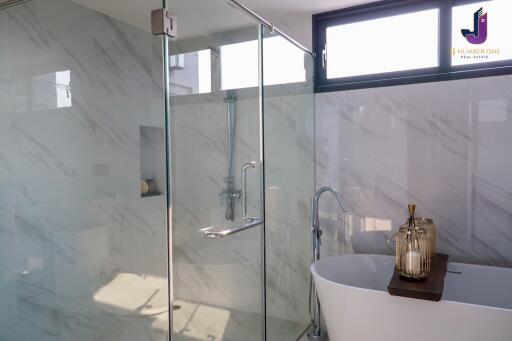 Modern bathroom with glass shower and freestanding tub