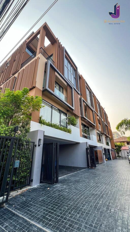 Three-story modern apartment building with balconies