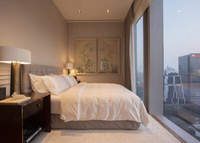 Modern bedroom with large windows and city view