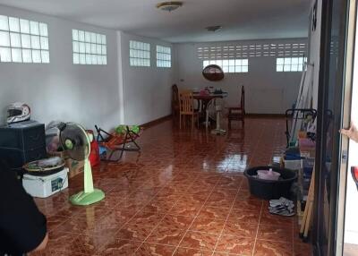 Spacious room with tiled flooring and some furniture