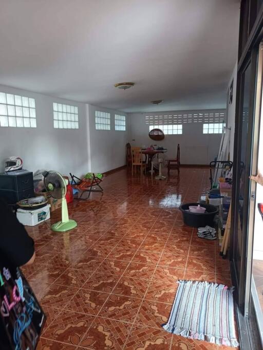 Spacious room with tiled flooring and some furniture