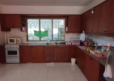 Spacious kitchen with wooden cabinets and a large window