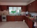 Spacious kitchen with wooden cabinets and a large window