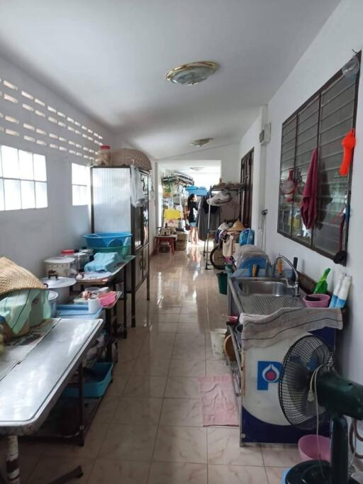 Long, narrow kitchen area with counter, sink, and window.