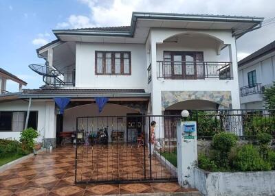 Two-story house with a tiled driveway and front yard