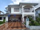 Two-story house with a tiled driveway and front yard