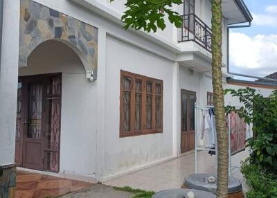 Two-story residential building with a front yard