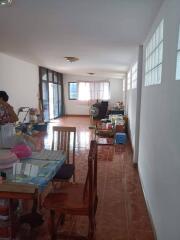 Spacious dining and living area with tiled floor