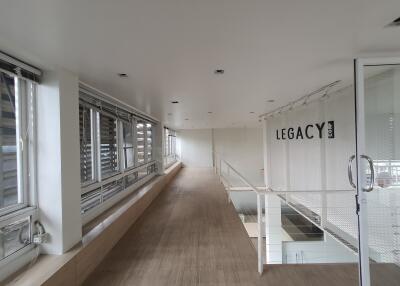 Modern hallway with large windows and glass door