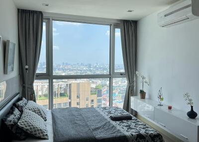 Spacious bedroom with large window and city view