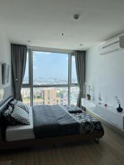 Spacious bedroom with large window and city view