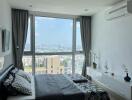 Spacious bedroom with large window and city view