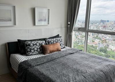 Bedroom with large windows and city view