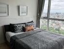 Bedroom with large windows and city view