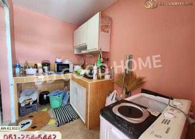 Small kitchen area with appliances and storage