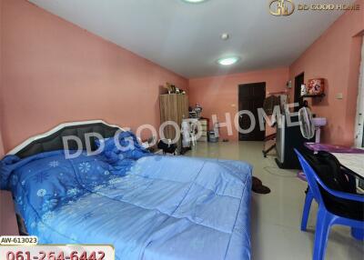 Spacious bedroom with blue bedding and pink walls