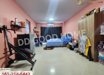 Spacious bedroom with exercise equipment, wardrobe, and bed