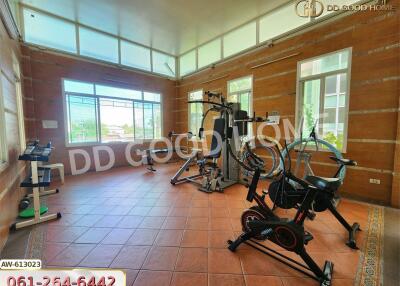 Spacious gym with modern workout equipment and large windows