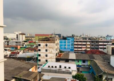 Cityscape view of multiple buildings under a cloudy sky