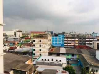 Cityscape view of multiple buildings under a cloudy sky