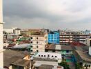 Cityscape view of multiple buildings under a cloudy sky